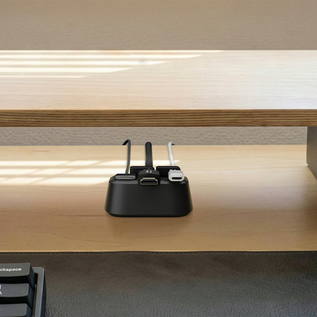 APP11145 - Magnetic Cable Holder | LD103 showing the magnetic cable holder organizing multiple cables beneath a wooden desk shelf