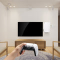 AMP06396 - Playstation 5 Console Mount | VG200 in white showing person's hand holding the controller while the console is attached to the wall using the mount
