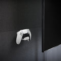 AMP06397 - PlayStation 5 Controller Mount | VG300 in White showing the front and partial side attached to a mount installed on a wall
