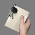 AFA08348 - Passport Holder in dune beige showing the front with carabiner attached for keys