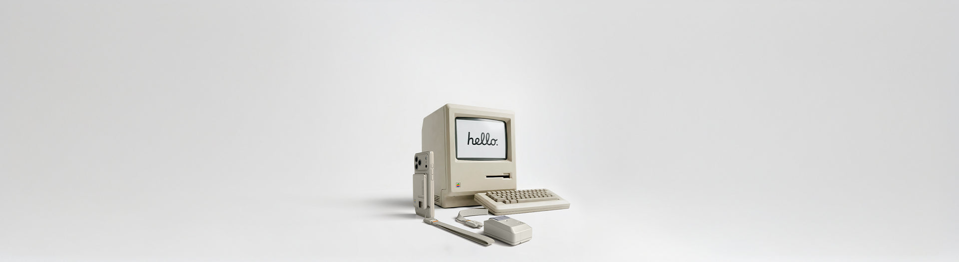 Plain white banner with retro style Mac computer, keyboard, and iPhone Classic LS phone case and Airpods Pro 3 case.