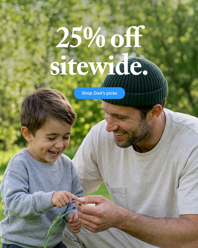 Father and young child playing outdoors in a park with 25% off sitewide promotional banner