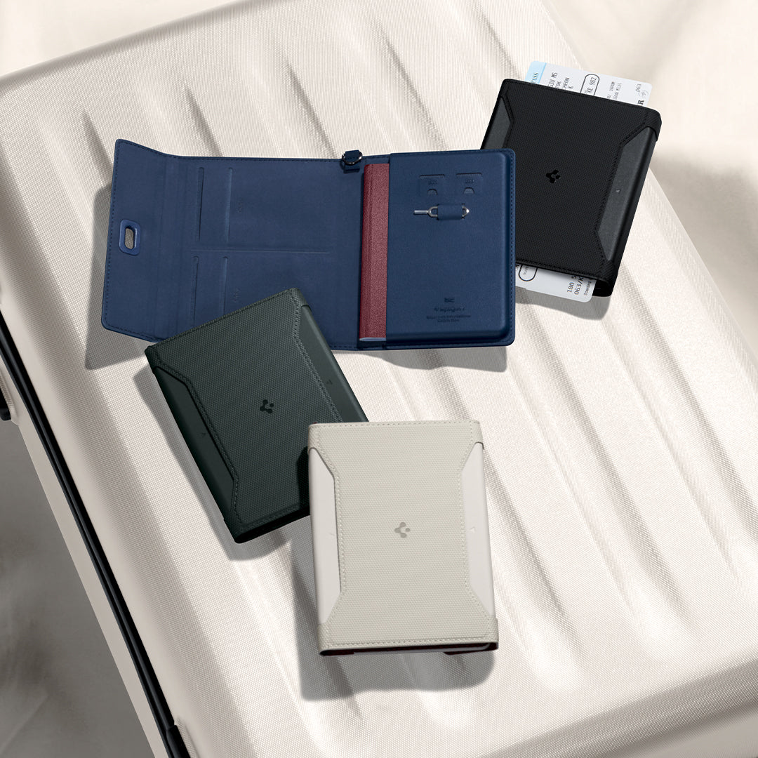 Showing the Spigen Passport holder in various colors on top of the white suitcase.