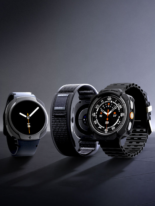 Four Samsung Galaxy Watch models with Spigen cases and bands in various styles on a dark surface