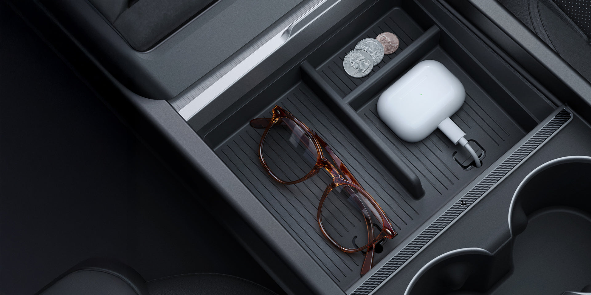 Showing the Tesla center console 3 section organizer with coins, airpod and glasses.