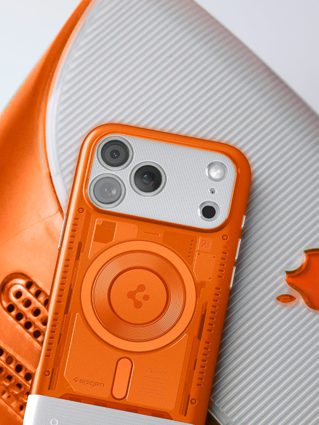 Spigen iPhone 17 Pro Classic case in orange featuring MagSafe ring and retro translucent design displayed on vintage Apple hardware