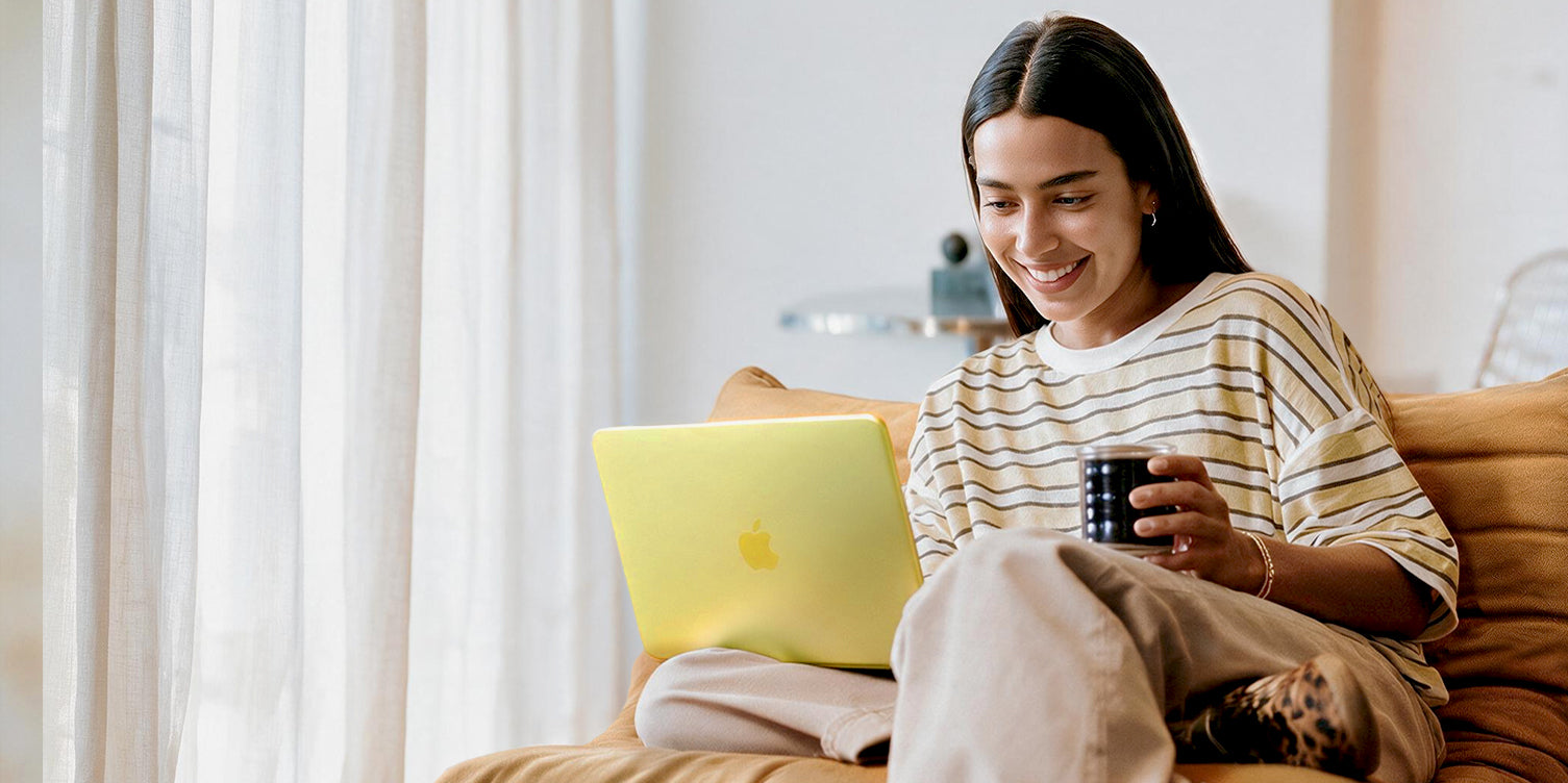 Girl look at macbook neo with hold coffee