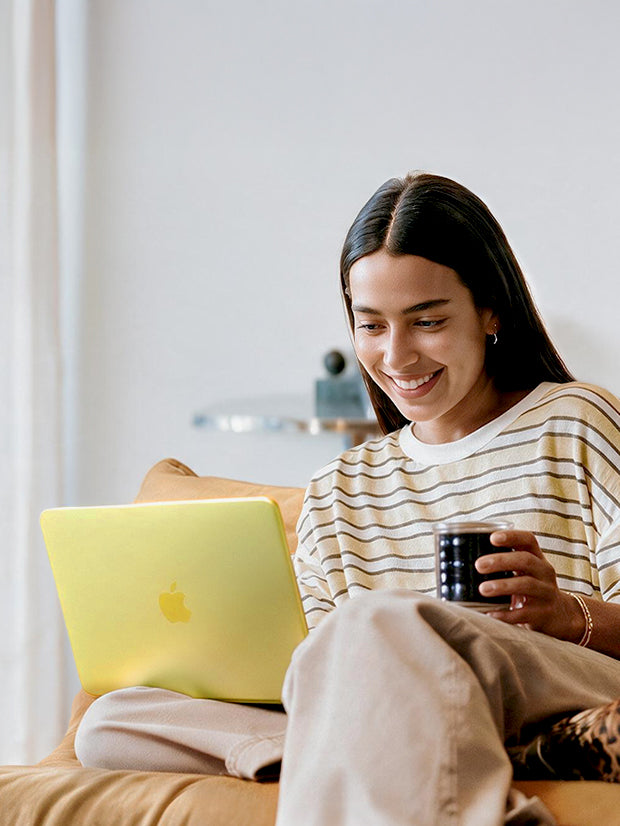 Girl look at macbook neo with hold coffee