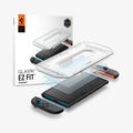 AGL10156 - Nintendo Switch 2 GLAS.tR EZ Fit in Clear showing the installation tray hovering above the film strip, screen protector and the device with the packaging on the side