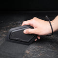 ACP11829 - Hand holding the Spigen car detailing scraper over a surface covered in pet hair
