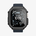 ACS11414 - Straight-on front view of Spigen Rugged Armor Apple Watch Ultra case displaying Rugged Armor and Shock Resist engravings with carbon fiber accents