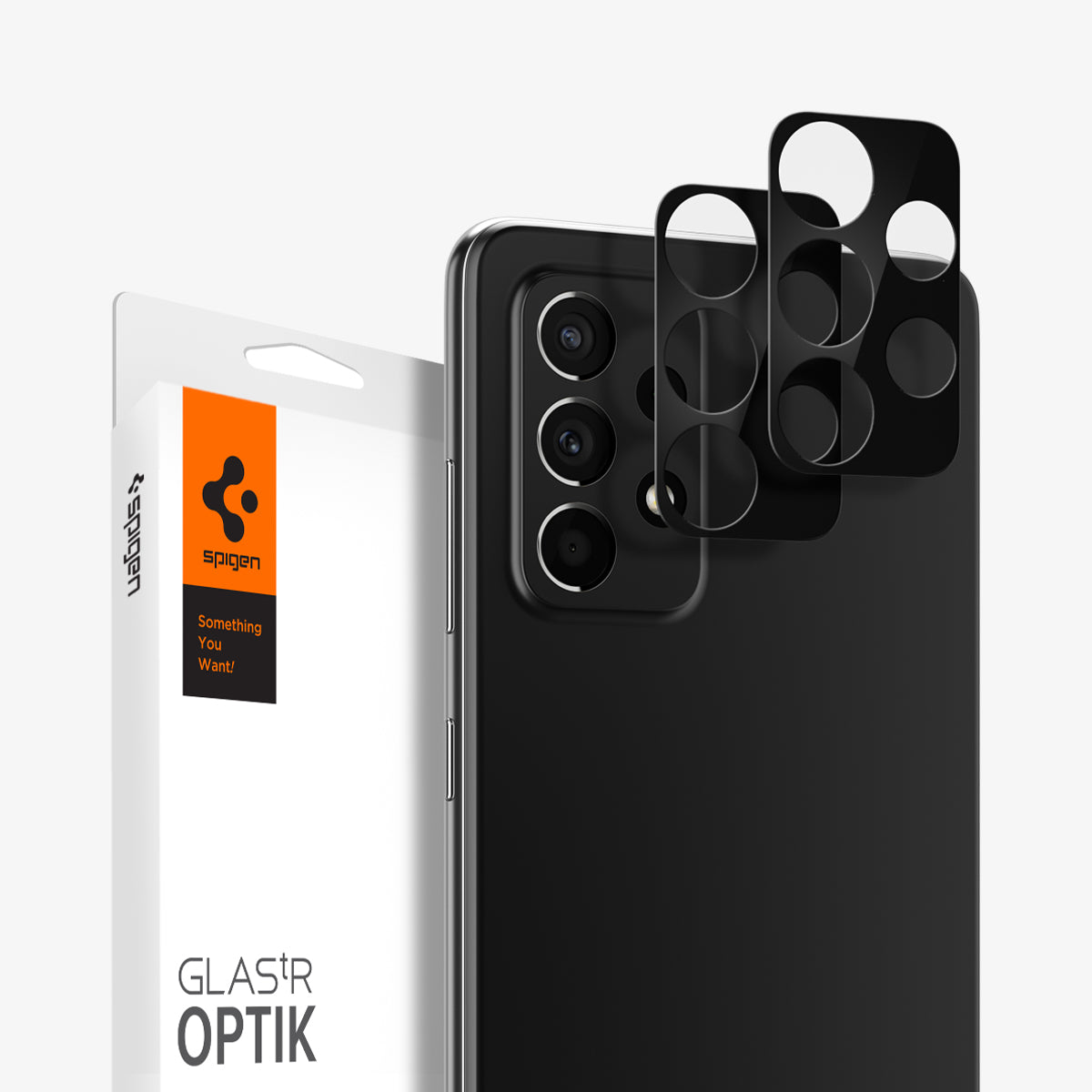 AGL02836 - Galaxy A52 Optik Lens Protector in Black showing the 2 lens tray hovering in front of a device, behind it, is a packaging