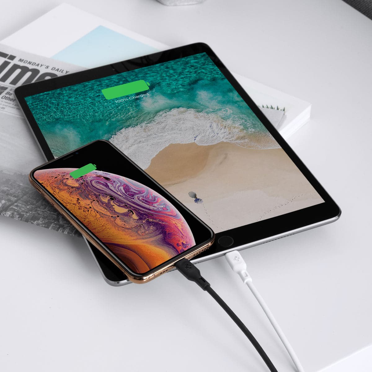 000CA25416 - DuraSync USB-C to Lightning Cable in white showing the two chargers charging a phone and tablet