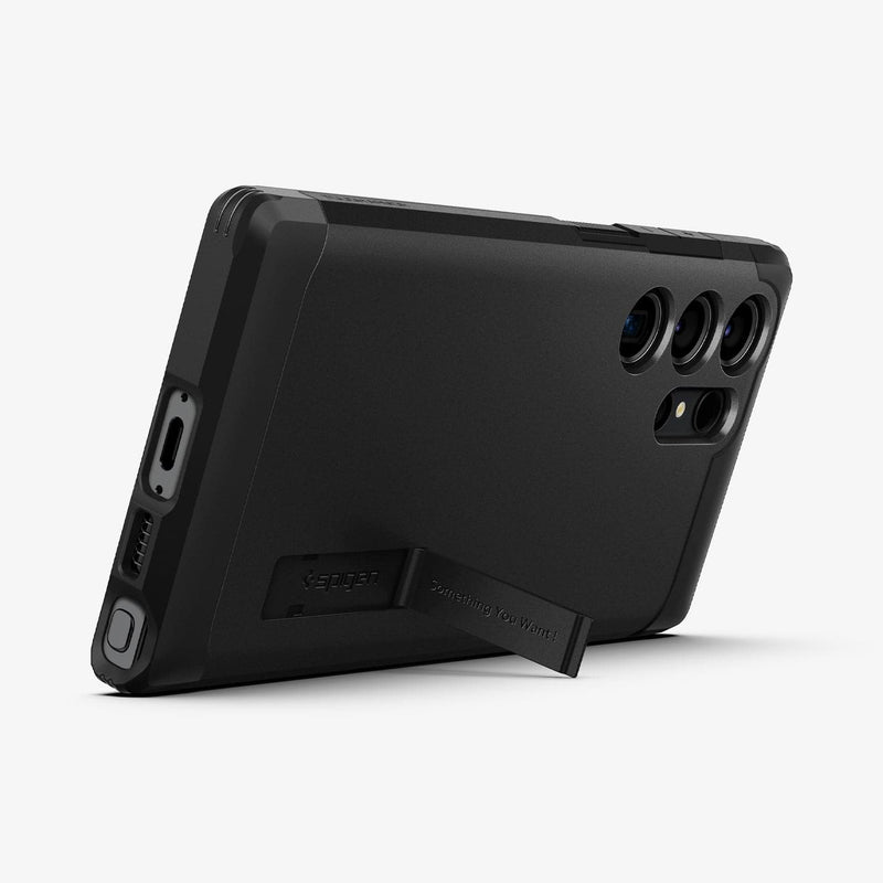 ACS05623 - Galaxy S23 Ultra Case Tough Armor in black showing the back and bottom with device propped up by built in kickstand