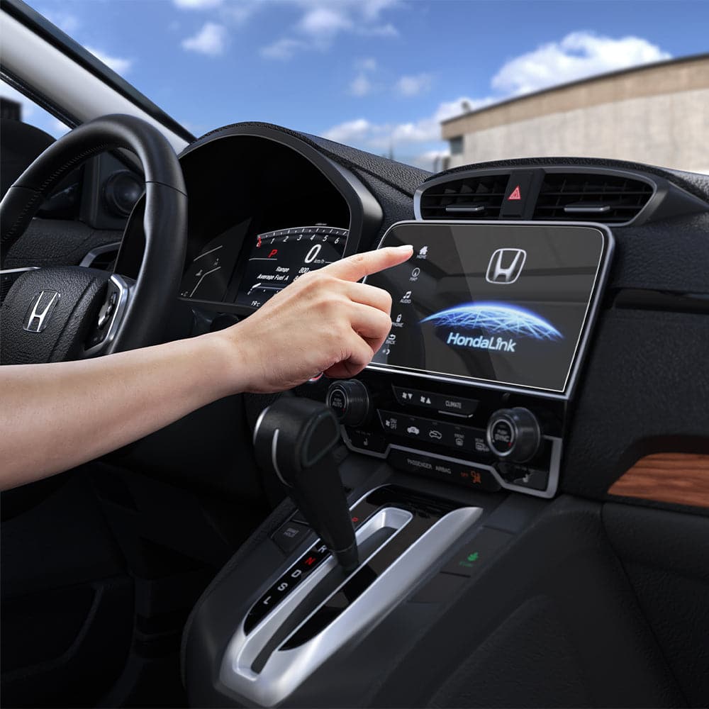 AGL04129 - Honda CR-V 7" Screen Protector GLAS.tR Slim Anti-Glare showing a hand reaching towards the display inside of car