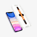 064GL25166 - iPhone 11 Screen Protector GLAS.tR EZ Fit showing the ez fit tray and screen protector hovering in front of device