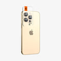 AGL05598 - iPhone 14 Pro / 14 Pro Max Optik Pro Lens Protector in gold showing the back and partial side with ez fit installed on camera lens