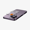 AGL05597 - iPhone 14 Pro / 14 Pro Max Optik Pro Lens Protector in deep purple showing the back with device laying flat and lens protector and ez fit tray hovering slightly above camera lens