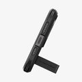 ACS06733 - iPhone 15 Pro Case Tough Armor (MagFit) in black showing the bottom with device propped up by built in kickstand