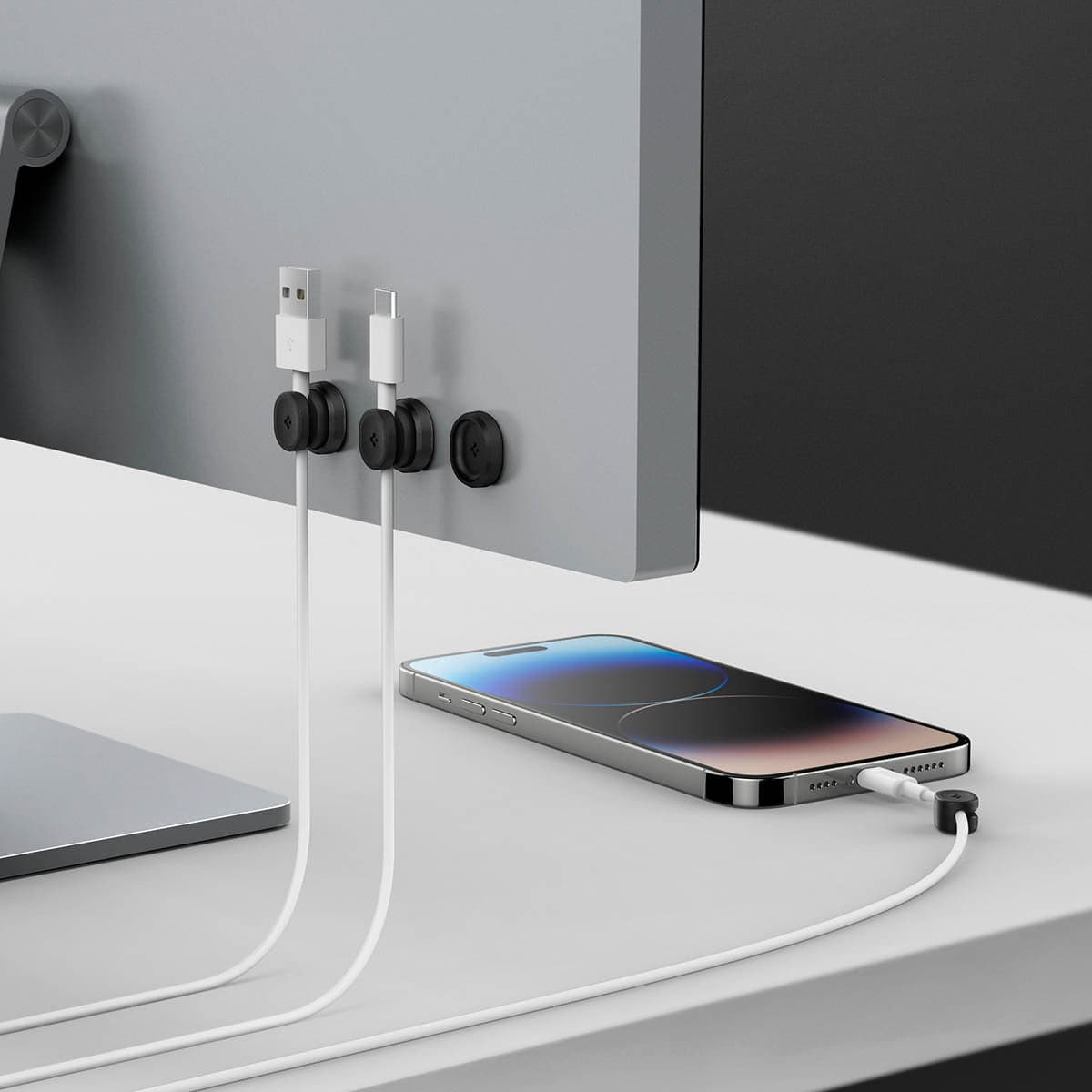 AMP05487 - LD102 Singular Magnetic Cable Organizer in black showing the cable holders mounted behind monitor with cables inserted