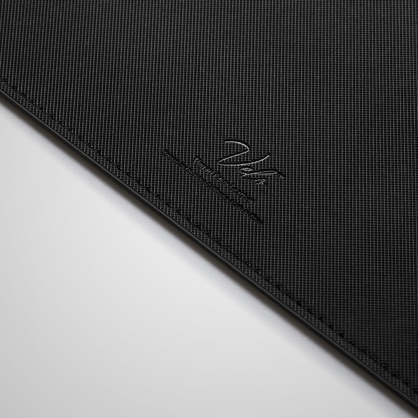 APP04760 - LD301 Mousepad in black showing the back zoomed in on vegan leather logo