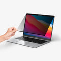 AFL06440 - MacBook Pro 13-inch Safe View in Privacy showing a hand installing the screen protector onto laptop