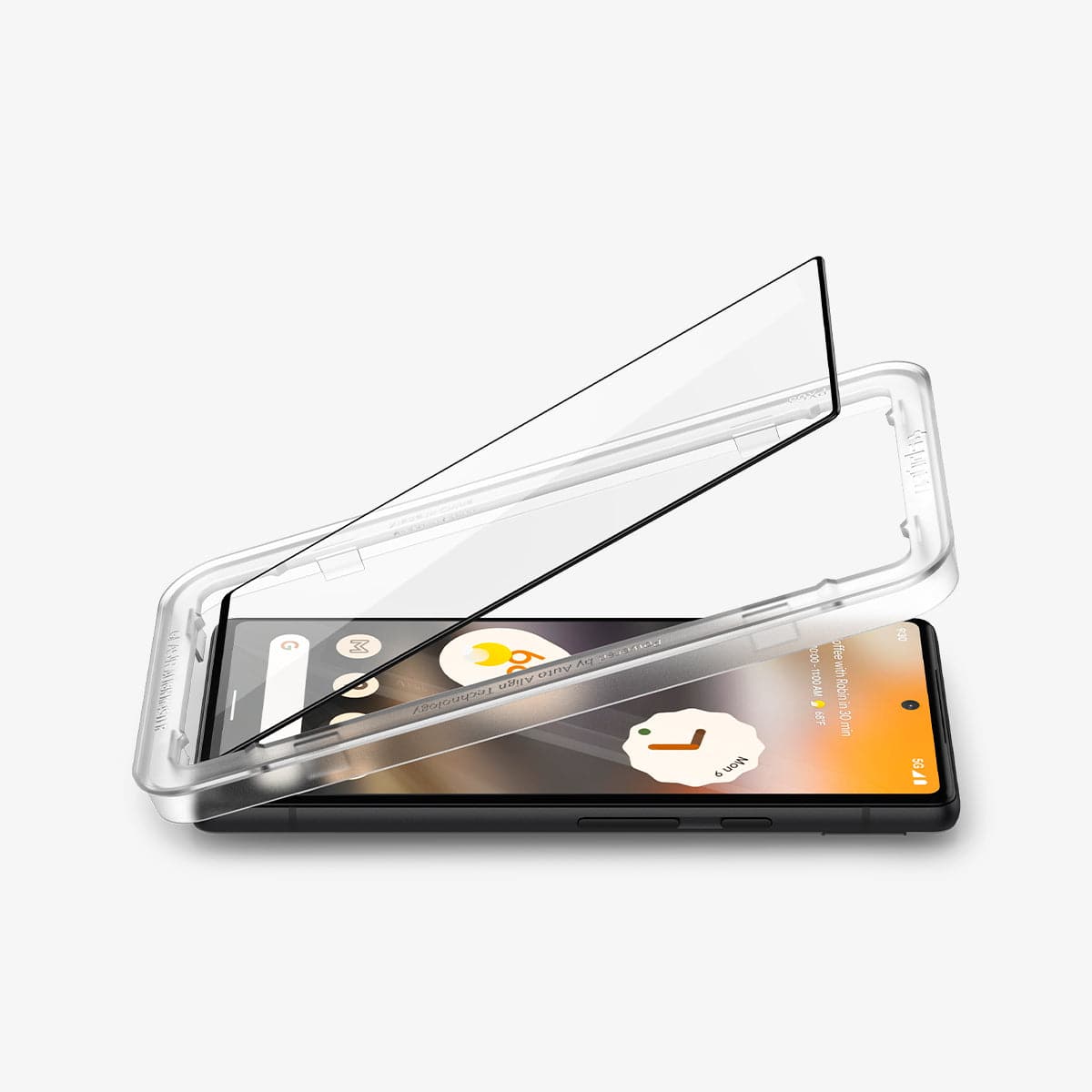 AGL04694 - Pixel 6a Screen Protector AlignMaster GLAS.tR Full Cover showing the device laying flat with alignmaster tray and screen protector being installed