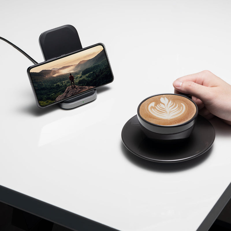 ACH06254 - ArcField PF2102 Wireless Charger in black showing a Samsung device charging horizontally with a video on the screen on a coffee table