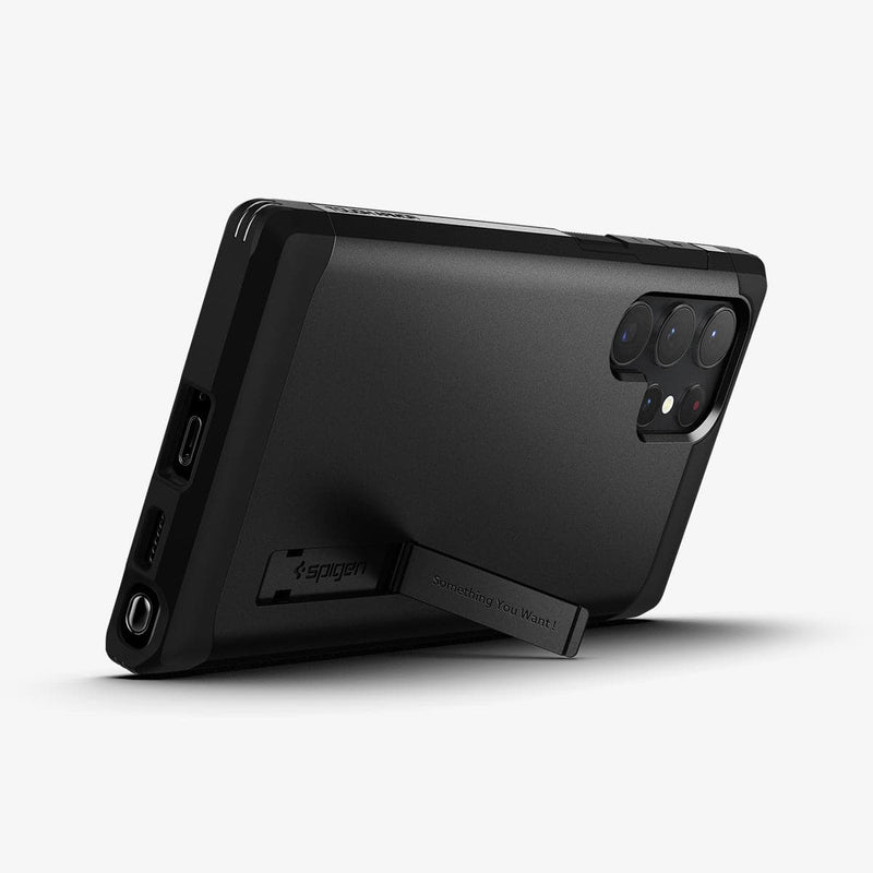 ACS03923 - Galaxy S22 Ultra 5G Case Tough Armor in black showing the back and bottom with device propped up by built in kickstand