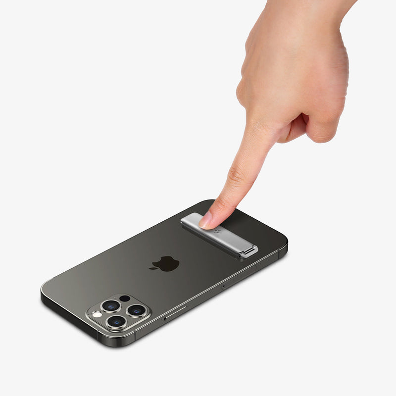 AMP03684 - U102 Universal Kickstand (Metal) in silver showing a finger pushing down the kickstand attached to back of device