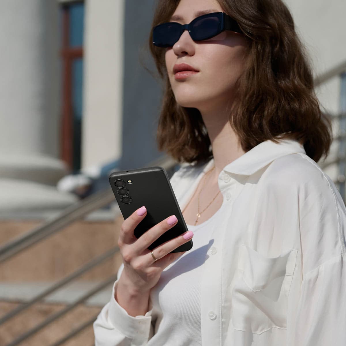 ACS05661 - Galaxy S23 Plus Case Thin Fit in black showing a woman outside with device in hand