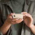 ACS06083 - Galaxy S23 Case Thin Fit in pearled ivory showing the device in someone's hand