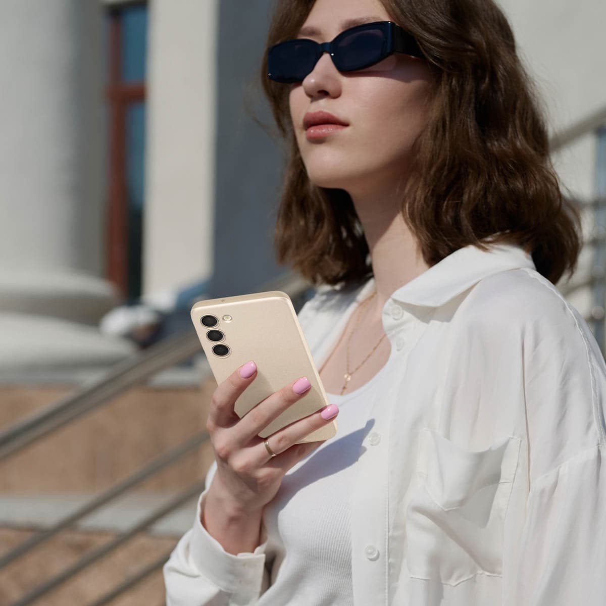 ACS06083 - Galaxy S23 Case Thin Fit in pearled ivory showing a woman outside with device in hand