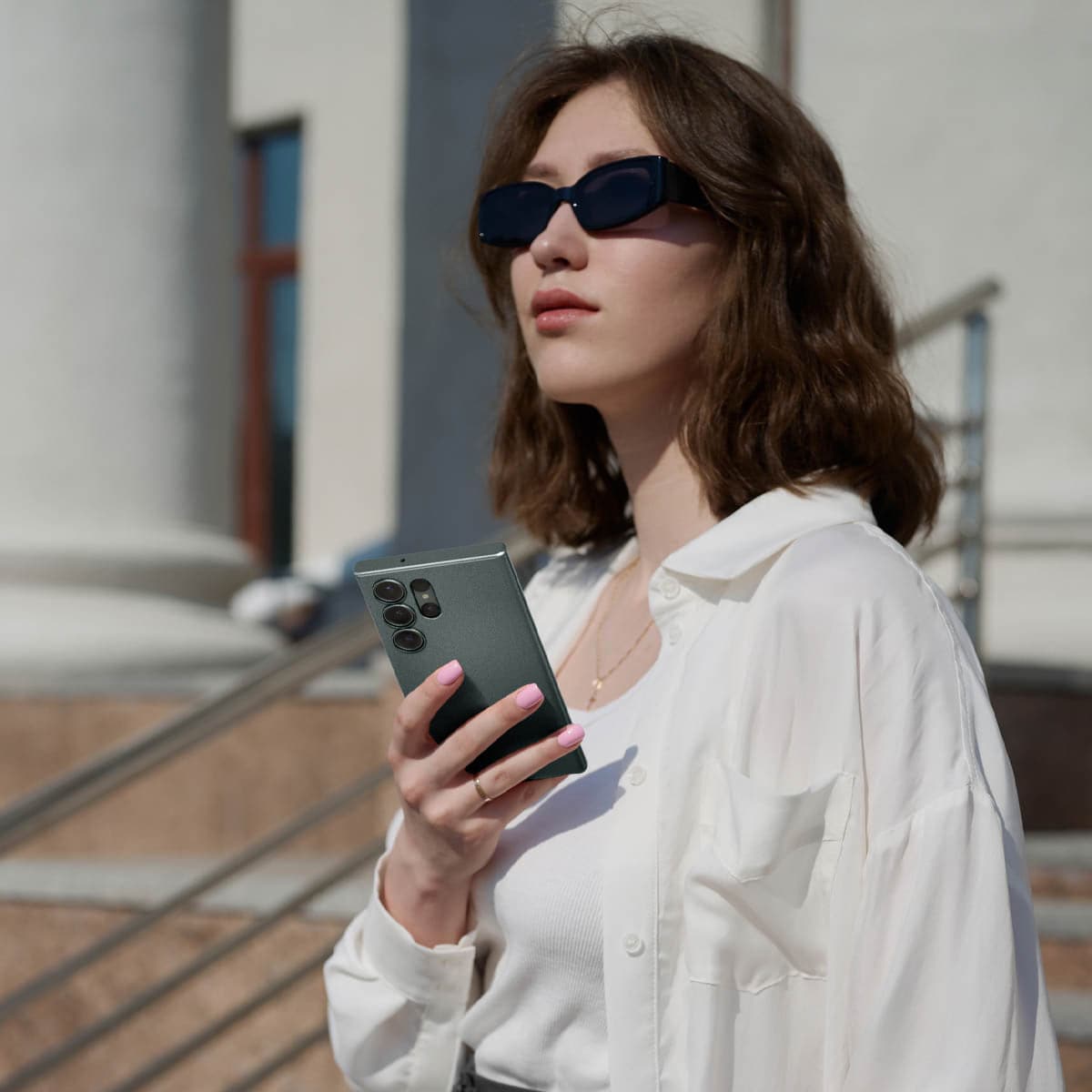 ACS06077 - Galaxy S23 Ultra Case Thin Fit in abyss green showing a woman outside with device in hand