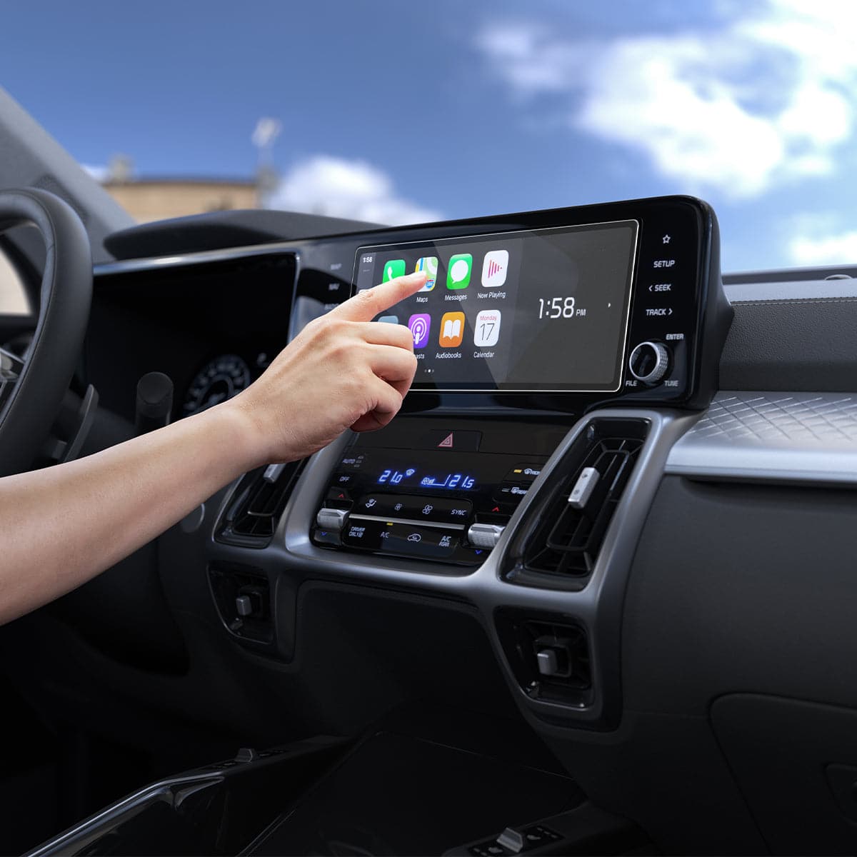 AGL04580 - Hyundai Tucson Screen Protector GLAS.tR SLIM Anti-Glare showing a hand reaching towards the display inside of the car